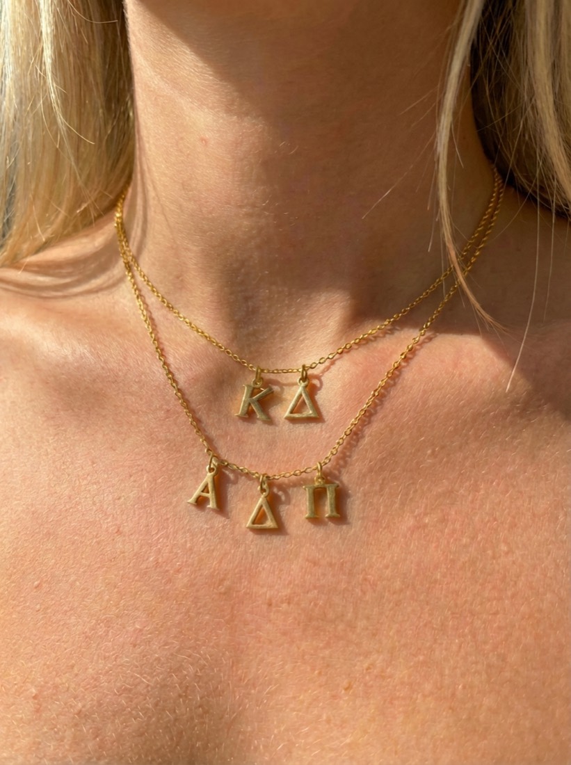A sister wearing her chapter's custom pendant necklace